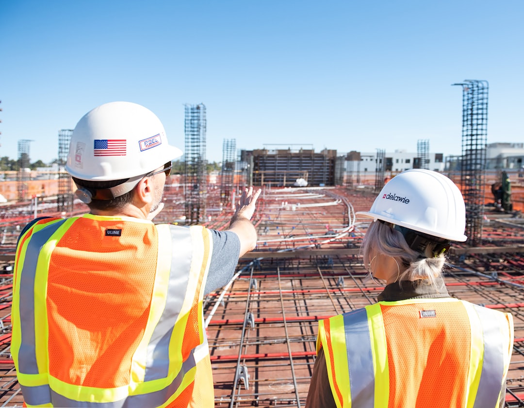 About man-in-white-hard-hat-standing-on-brown-wooden-dock-during-daytime-80zz1s24nag